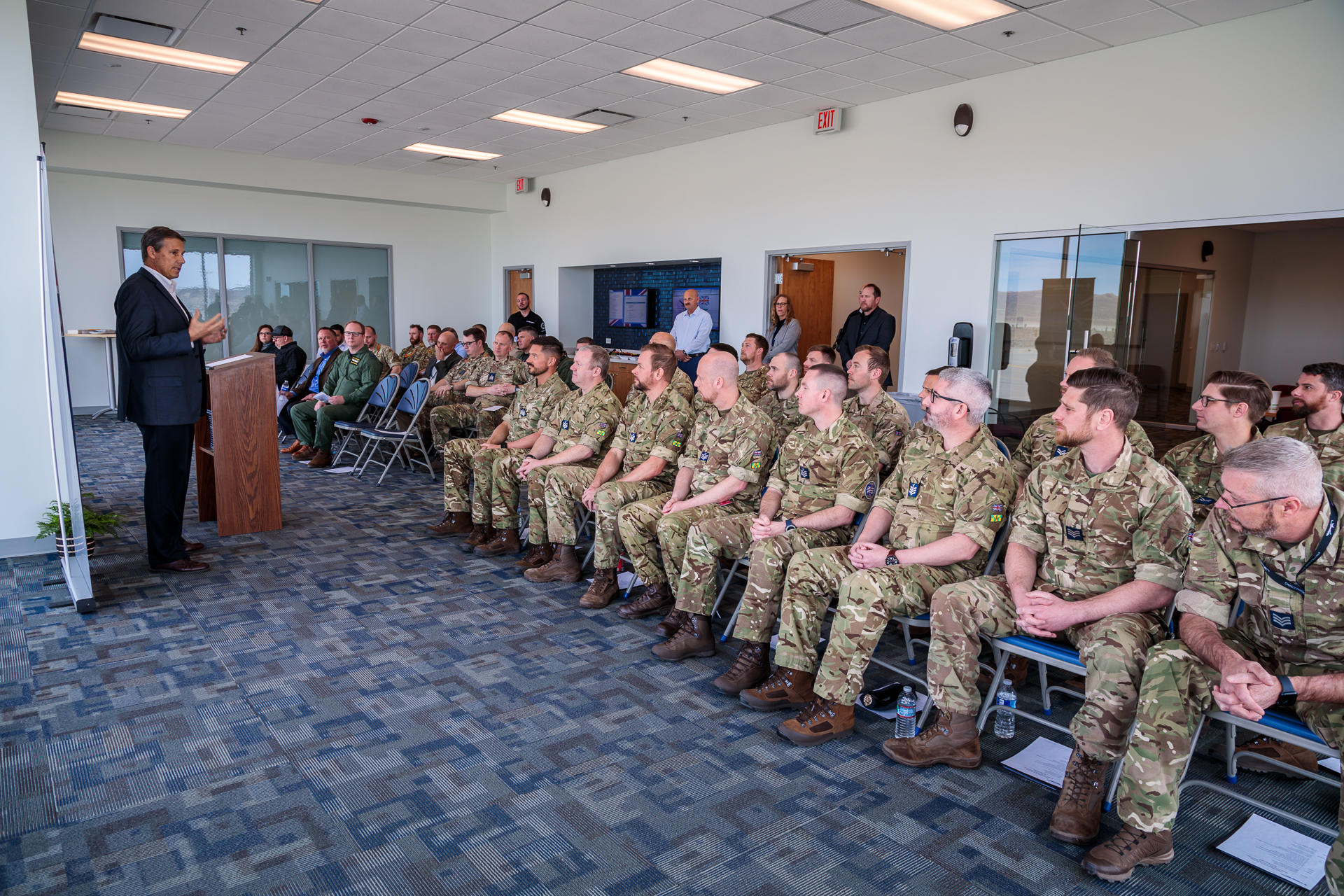 Image shows RAF aviators sitting in the audience of a presentation room before speaker.